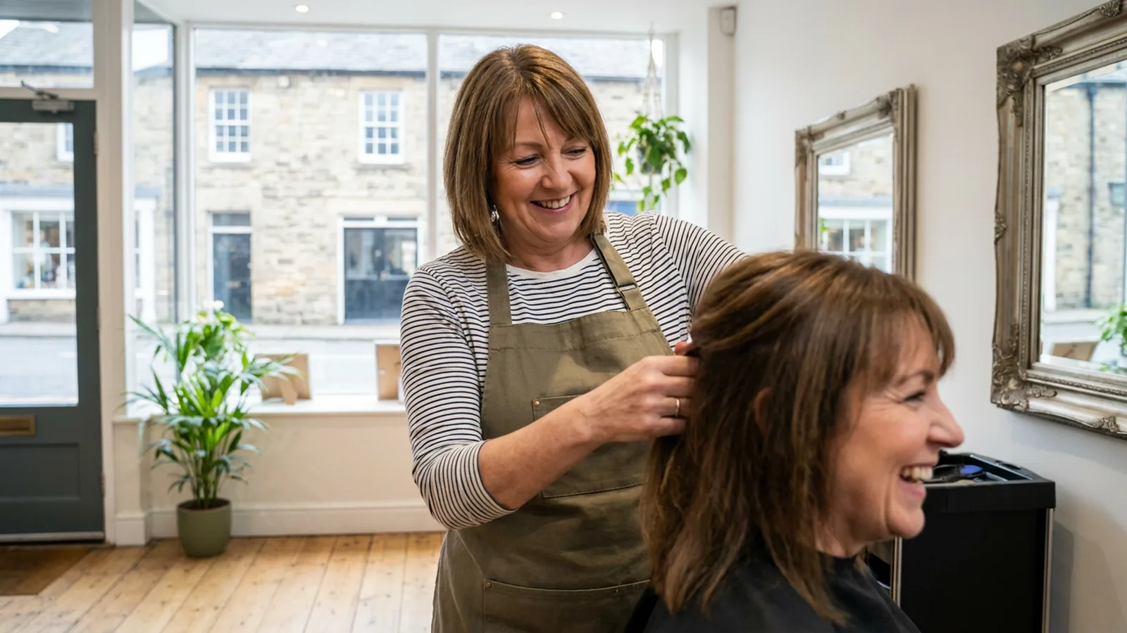 Hairdresser styling a client in a bright local salon